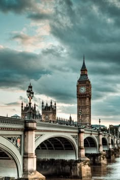 the big ben clock tower towering over the city of london, england as seen from across the river thames