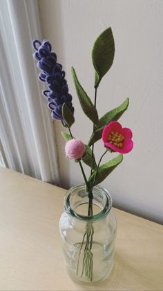 a vase with flowers in it sitting on a table next to a window sill