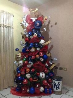 a christmas tree is decorated with red, white and blue ornaments in the shape of baseballs