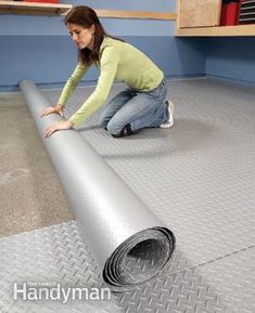 a woman laying on the floor next to a roll of duct tape and looking at it