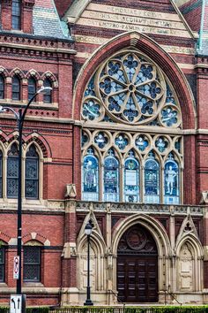 an old church with stained glass windows on it's front and side doors,