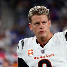 a close up of a football player holding his arm in the air with one hand