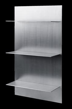 three metal shelves are stacked on top of each other, one is empty and the other has