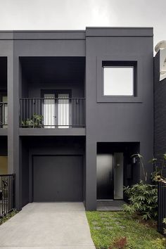 an apartment building with two balconies on the second floor