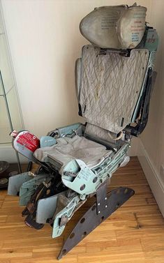 an open suitcase sitting on top of a hard wood floor next to a pile of shoes