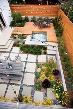 an aerial view of a small backyard with a hot tub and seating area in the middle