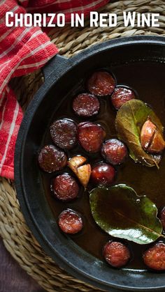 a bowl filled with food sitting on top of a table next to a red and white checkered napkin