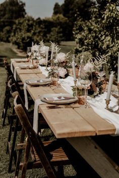 a long wooden table with place settings on it