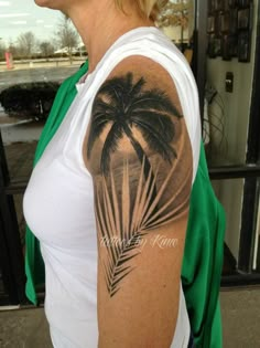 a woman with a palm tree tattoo on her arm