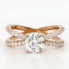 an engagement ring with two bands and a round diamond