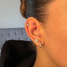 a close up of a person with ear piercings on their left and right sides