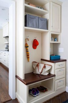 an open closet with shoes and bags on the shelves