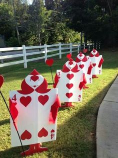 the lawn is decorated with red and white playing cards for valentine's day decorations