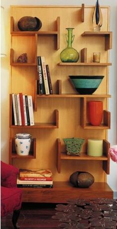 a wooden shelf filled with books and vases