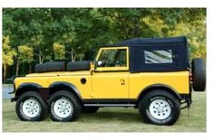 a yellow and black truck parked in the grass