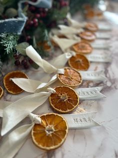 orange slices are tied to ribbons on a table