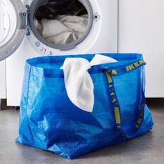 a laundry bag sitting next to a washing machine