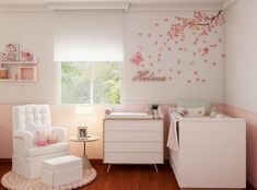 a baby's room with white furniture and pink decor on the walls, along with a cherry blossom wall decal