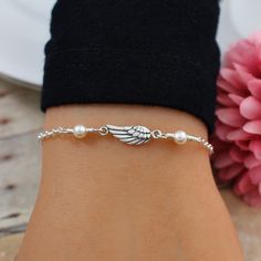 Angel Wing Bracelet.  This beautiful Angel Wing Bracelet features a dainty Sterling Silver Angel Wing accented with two Pearl or Crystal colors of your choice on a sterling silver cable chain finished with a lobster clasp closure.  Bracelet is solid sterling silver, fully adjustable and comes with the option to add a complimentary, custom printed gift note. ANGEL BRACELET DETAILS: * Strong sterling silver cable chain finished with a secure lobster clasp closure * Bracelet is adjustable with one Swarovski Pearls Bracelet, Angel Wing Bracelet, Angel Wings Jewelry, Angel Bracelet, Crystal Colors, Silver Angel Wings, Angel Jewelry, Bracelet Pearl, Crystal Angels