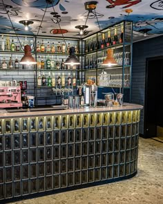 the bar is decorated with many different types of bottles and glasses on it's shelves