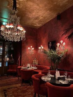 a fancy restaurant with red walls and chandeliers