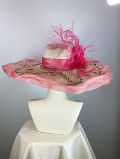 This ivory, pink and green women's straw hat is so pretty! It is completely handmade, hand blocked and one of a kind. The hat is topped with a sinamay straw brim that I tinted then embellished with a leafy vine. It's further embellished with a peachy pink silk band, handmade silk flower and wispy distressed crinoline. It is perfect for a special occasion like Kentucky Derby, Kentucky Oaks, church or summer garden party. The Wide brim makes a statement, as does the slightly asymmetrical crown. A Summer Sinamay Hat Costume Headpiece, Handmade Short Brim Hat For Royal Ascot, Whimsical Mini Hats With Curved Brim For Beach, Kentucky Derby Curved Brim Costume Hats, Kentucky Derby Straw Hat With Wide Brim In Sinamay, Curved Brim Kentucky Derby Hats, Kentucky Derby Sinamay Straw Hat With Wide Brim, Kentucky Derby Costume Hat With Curved Brim, Kentucky Derby Wide Brim Straw Hat In Sinamay