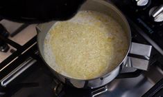 a pot filled with food sitting on top of a stove next to a burner