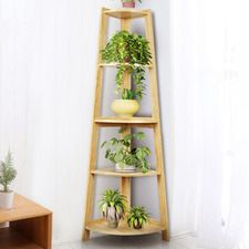 a wooden shelf filled with potted plants on top of a white floor next to a window