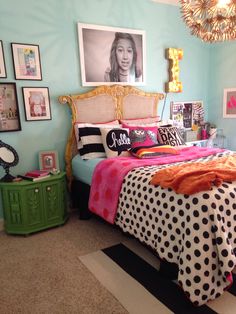 a bedroom decorated in pink, black and white polka dots