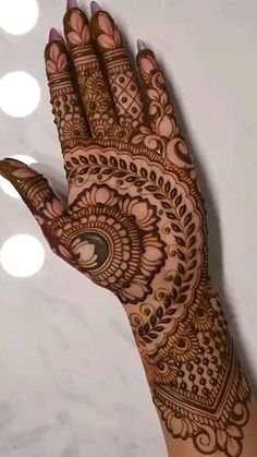 a woman's hand with henna on it