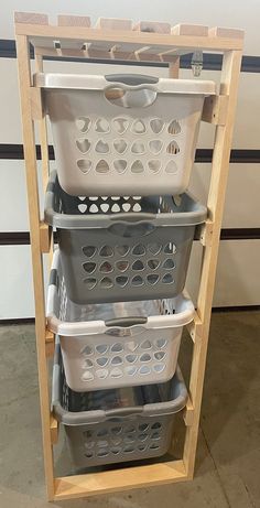 three plastic baskets stacked on top of each other in a storage rack with wooden shelves