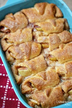 a blue casserole dish filled with apples