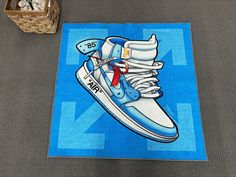 a blue rug with a pair of sneakers on it