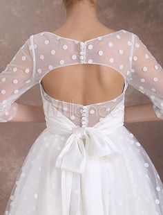 the back of a woman's dress with white polka dots on it