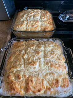 two baking pans filled with food sitting on top of a stovetop next to each other