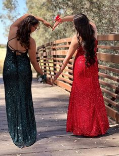 two women standing on a bridge holding hands