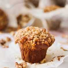 a muffin sitting on top of a white napkin