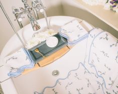 a bathtub with flowers and towels on it