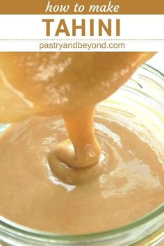 a jar filled with peanut butter and caramel being drizzled over it