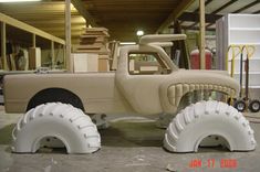 a truck made out of tires in a garage