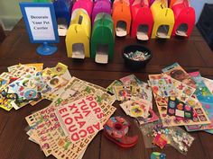 there are many different types of stickers on the table and in front of them is a sign that says, decorate your pet center