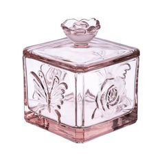 a glass box with a flower on the top and a butterfly on the bottom, sitting in front of a white background