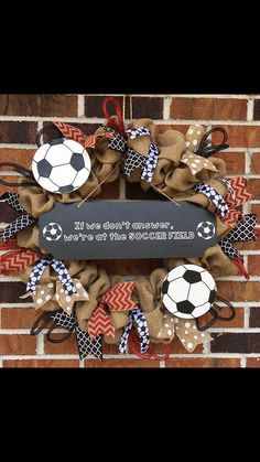 a soccer themed wreath on a brick wall