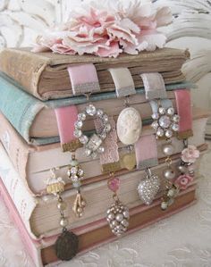 a stack of books sitting on top of each other next to a bouquet of flowers