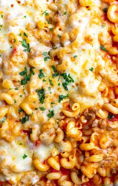 macaroni and cheese with parsley on top in a white dish, ready to be eaten