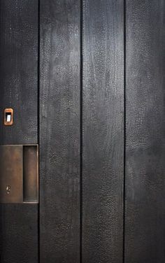 the door is made of wood and has a metal handle on it's side