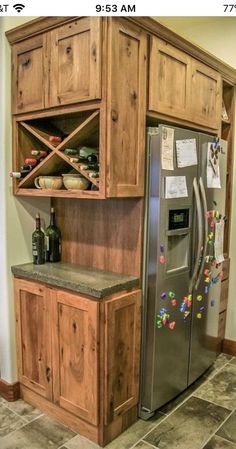 a refrigerator freezer sitting inside of a kitchen next to a wooden cabinet and counter