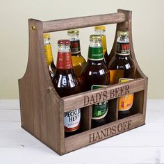 a wooden crate filled with beer bottles on top of a table