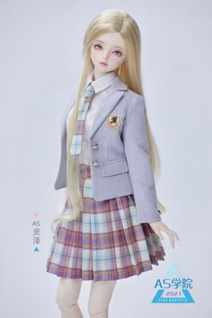 a doll dressed in a school uniform with long blonde hair wearing a skirt and jacket