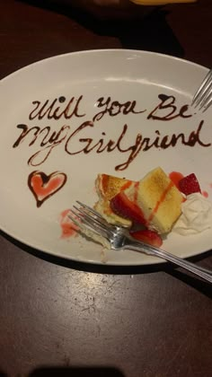 a piece of cake on a plate with the words will you be my girlfriend written on it